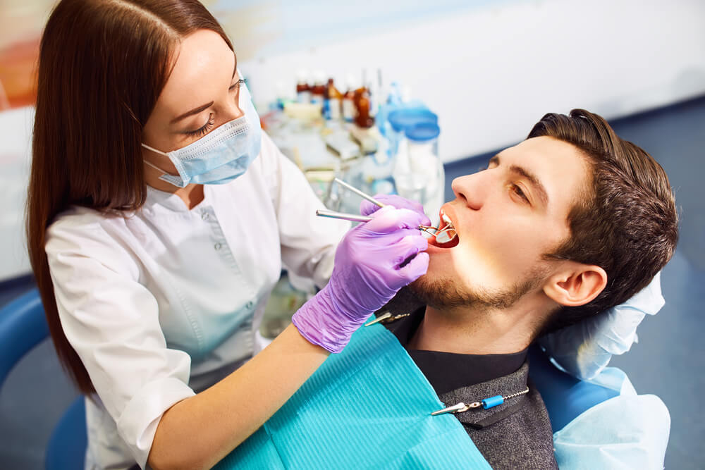 man at the dentist's chair during a dental procedure